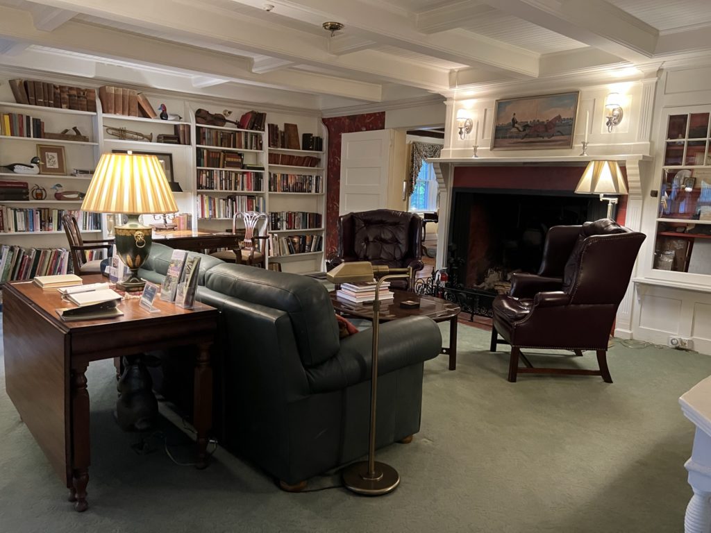 Den with book shelf and seating at Inn at Ormsby Hill