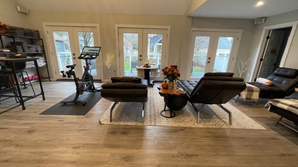 Indoor living area with a stationary bike and chairs at the Phineas Swann Inn & Spa