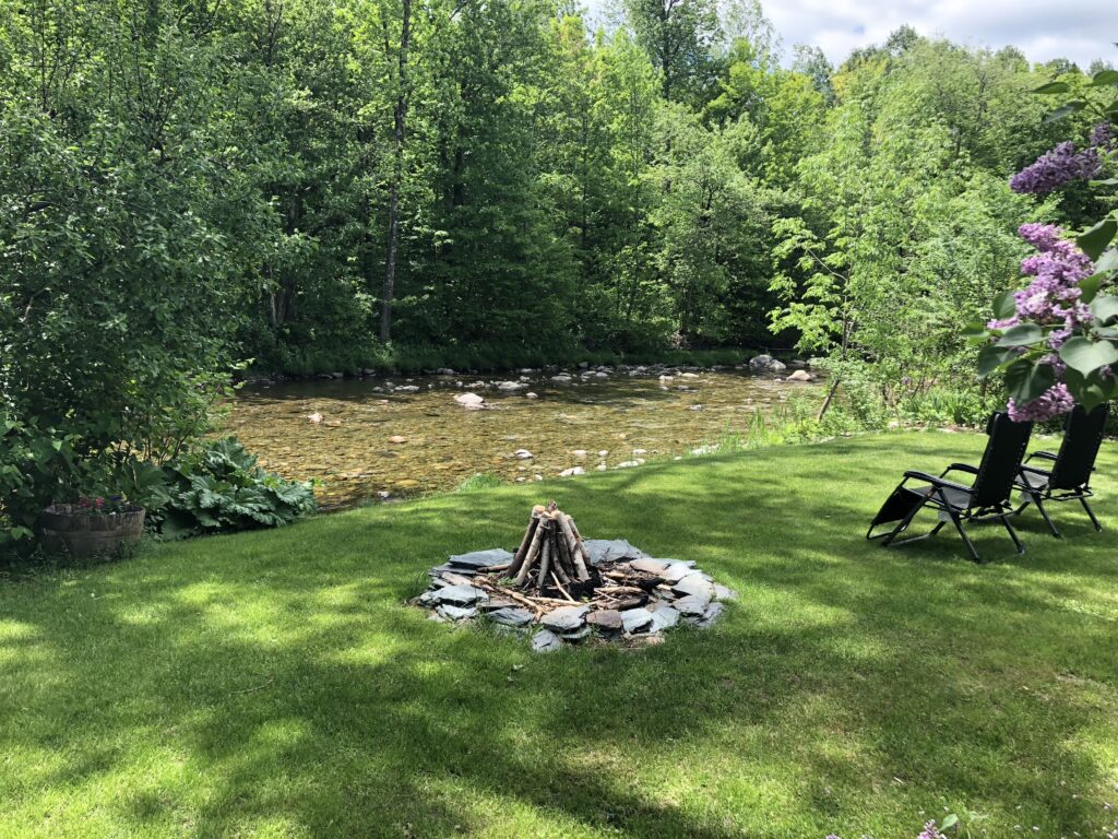 River front area and campfire of the Phineas Swann Inn & Spa